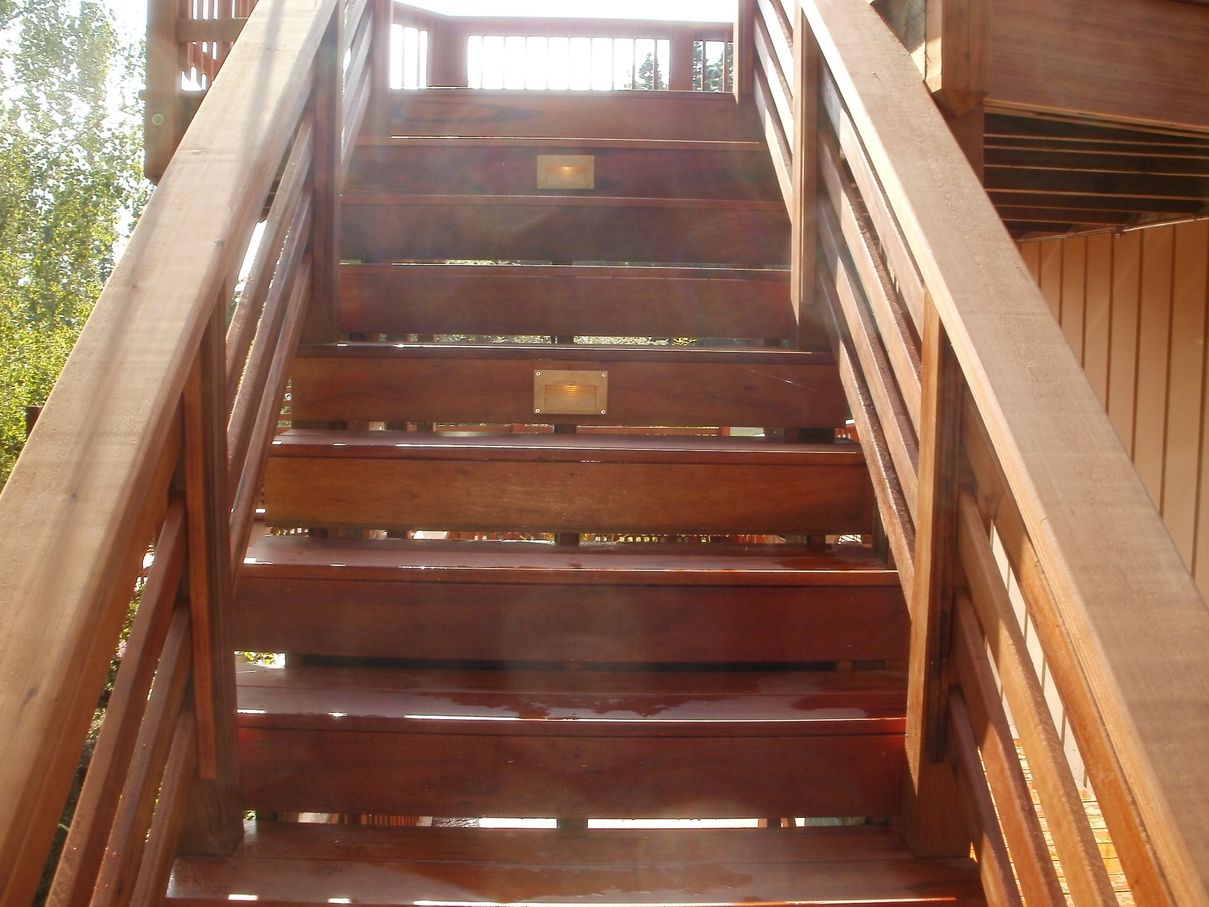 Custom exterior stairs in clear-grain redwood and tigerwood with recessed low-voltage riser lights