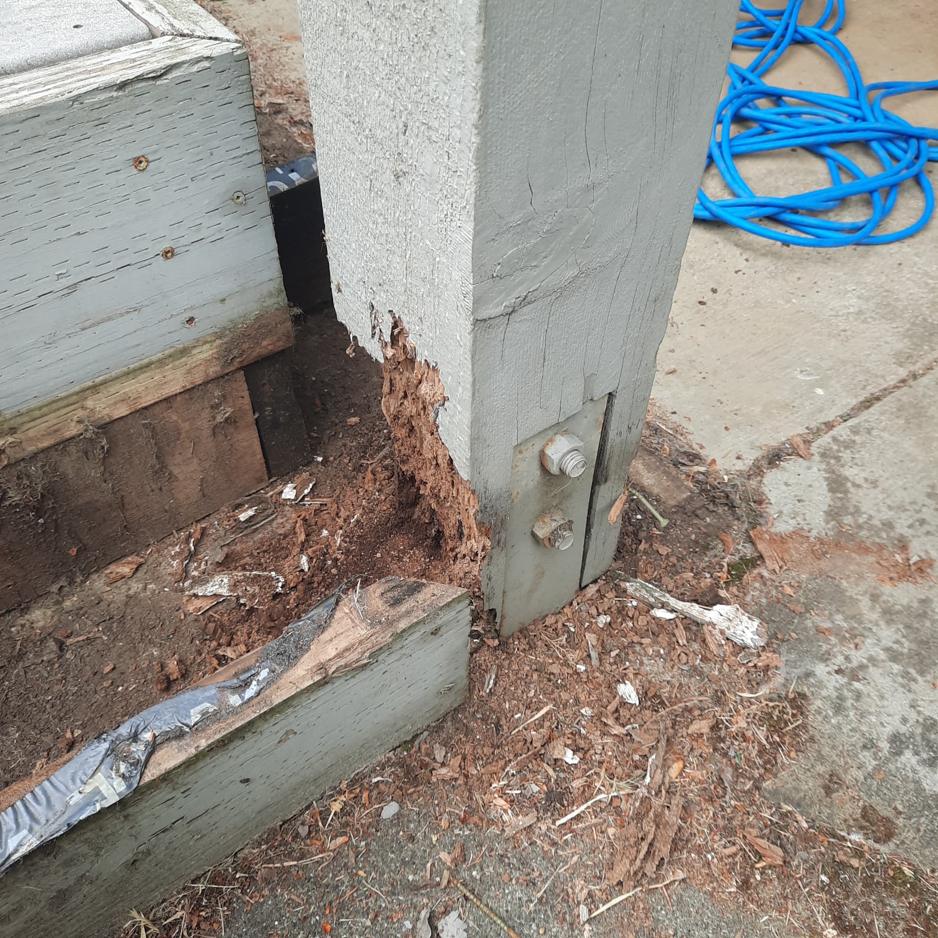 Deteriorated deck post and framing connection before repair