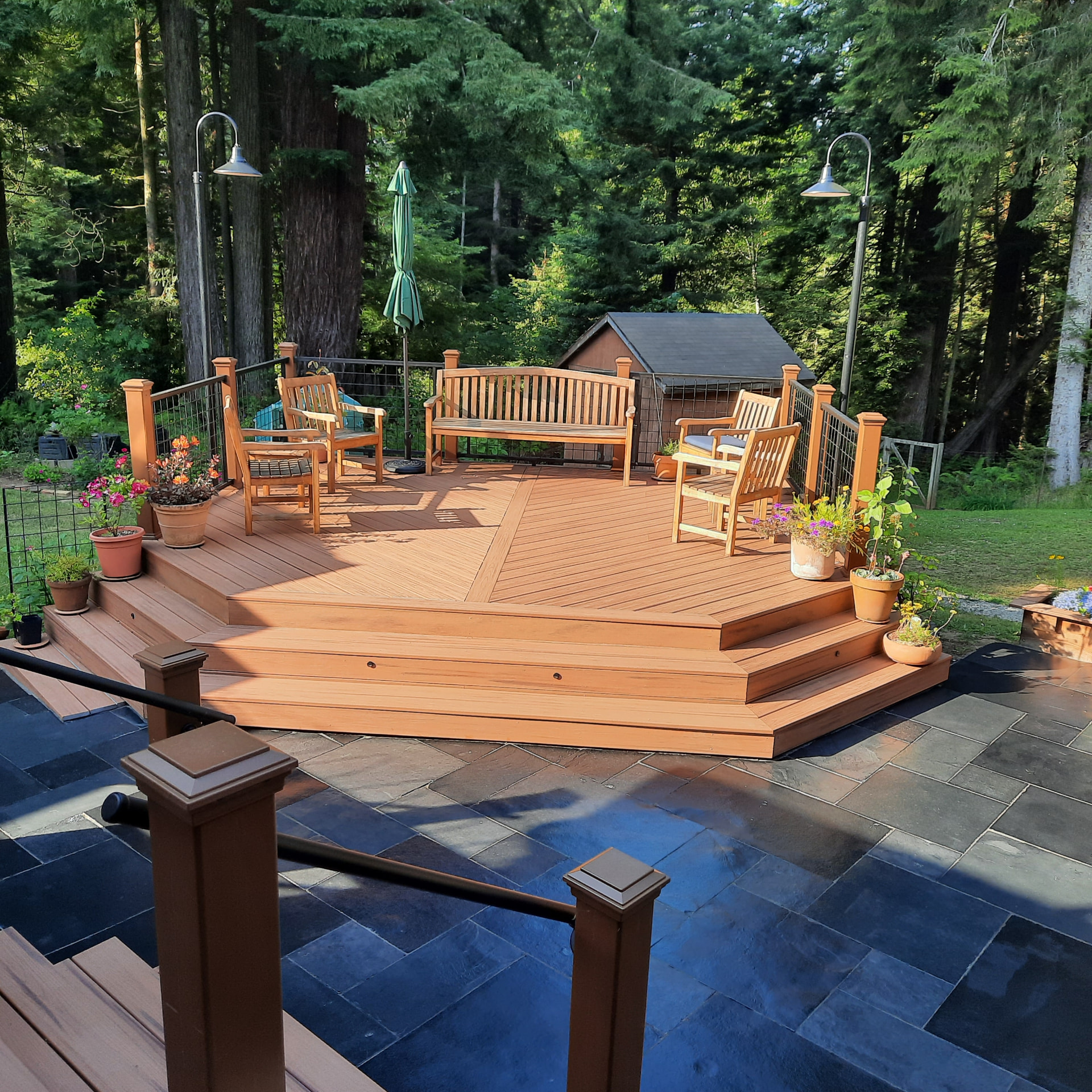 Star outdoor-living deck with stairs and railing seen from the yard