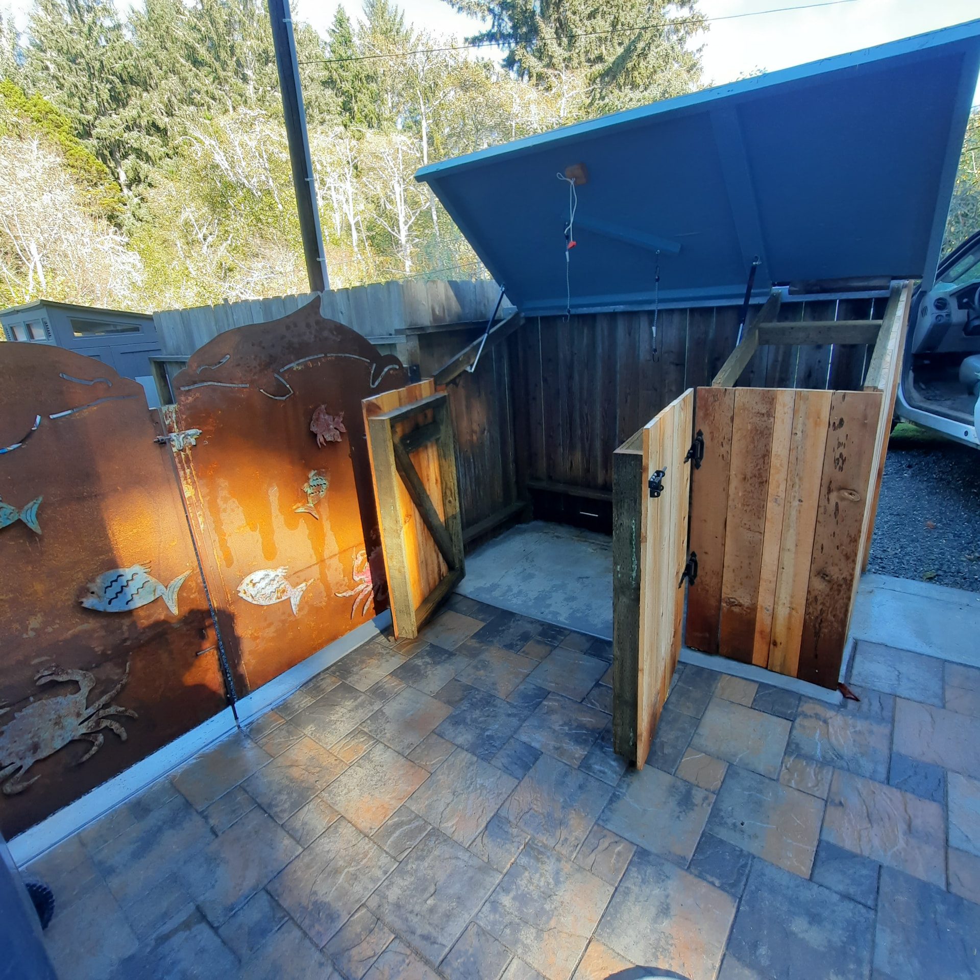 Custom bear-resistant trash receptacle enclosure with lift lid and hinged wood doors