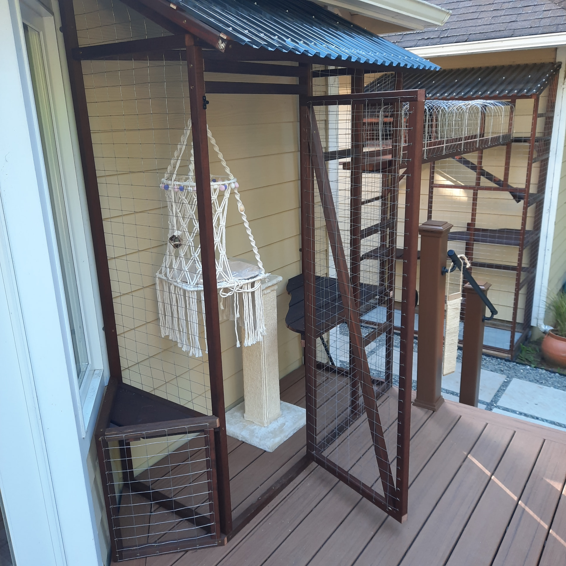 Catio access door, shelving, and interior perches built against the house and deck