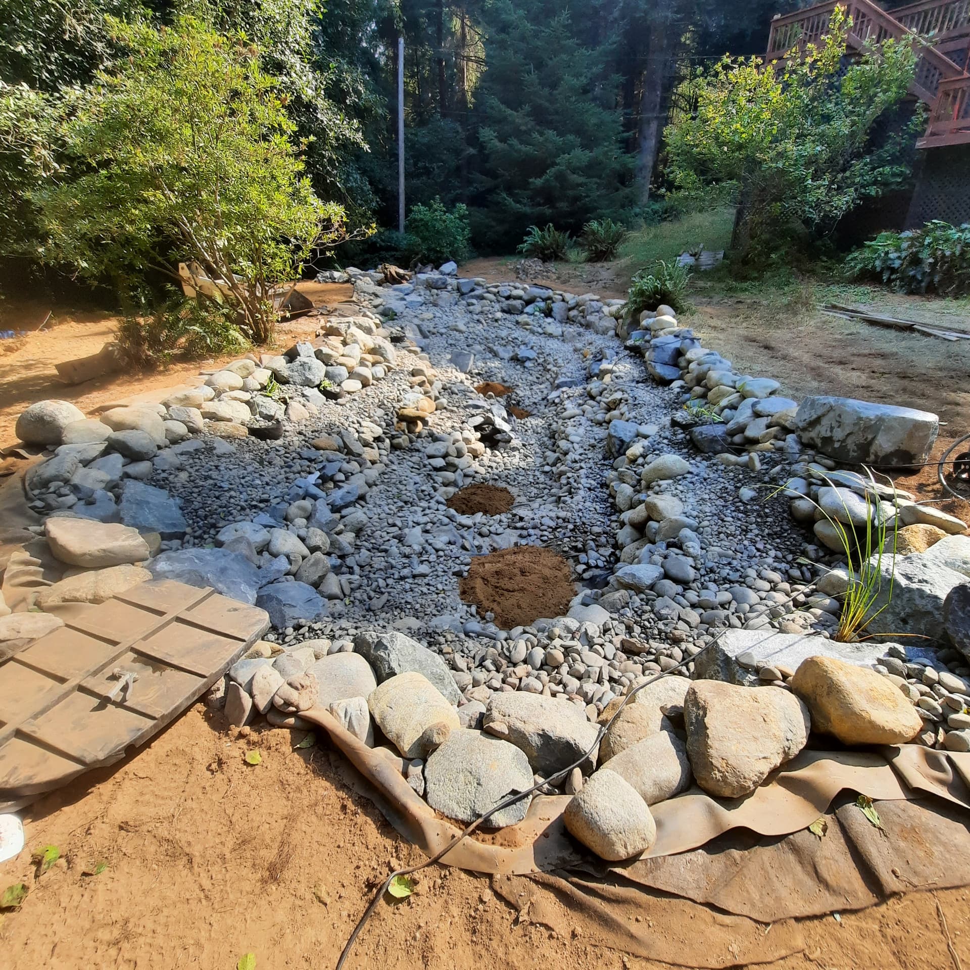 Finished creek and upper pond edge with placed boulders and cobble