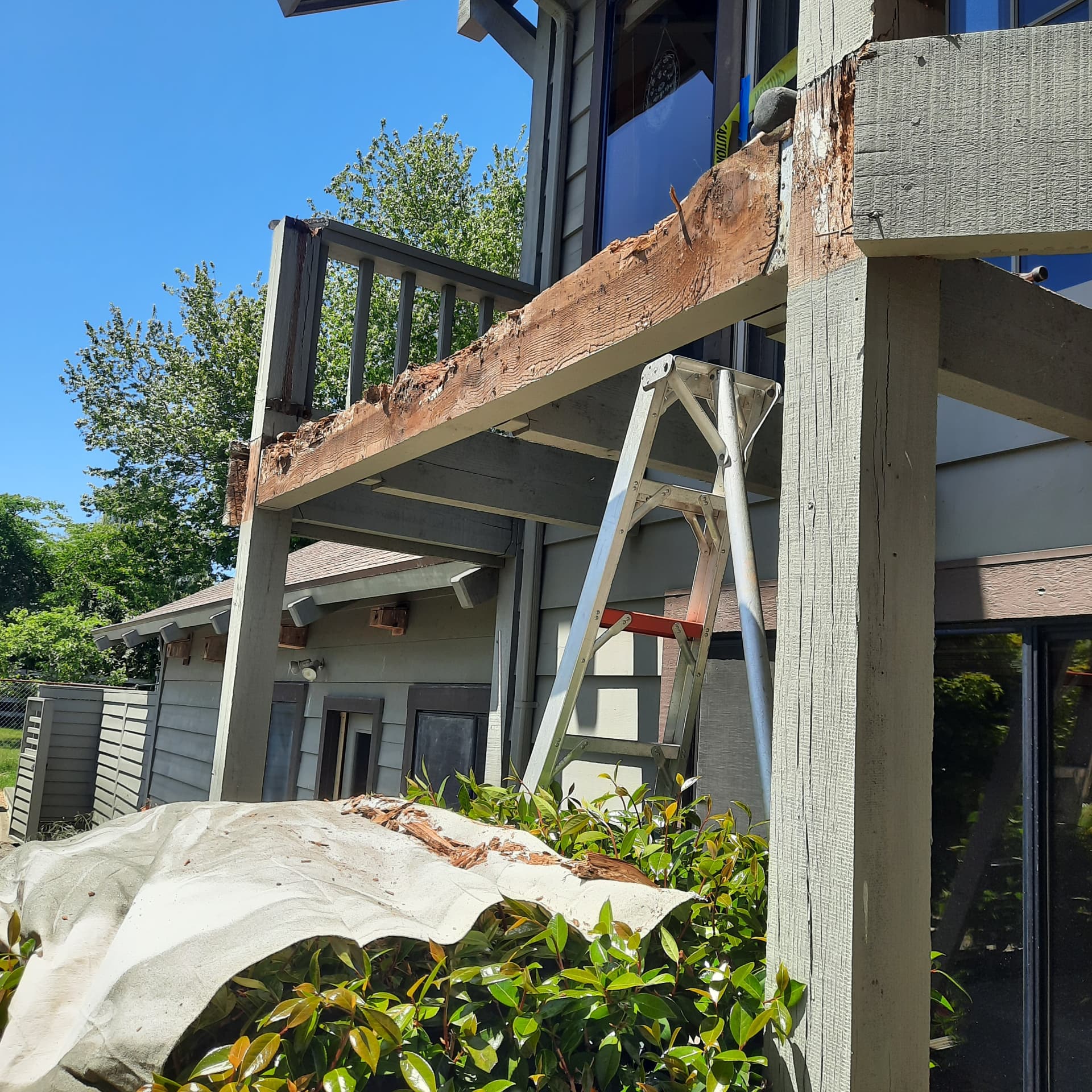 Significant rot and structural deterioration in the aging balcony's support beam before replacement
